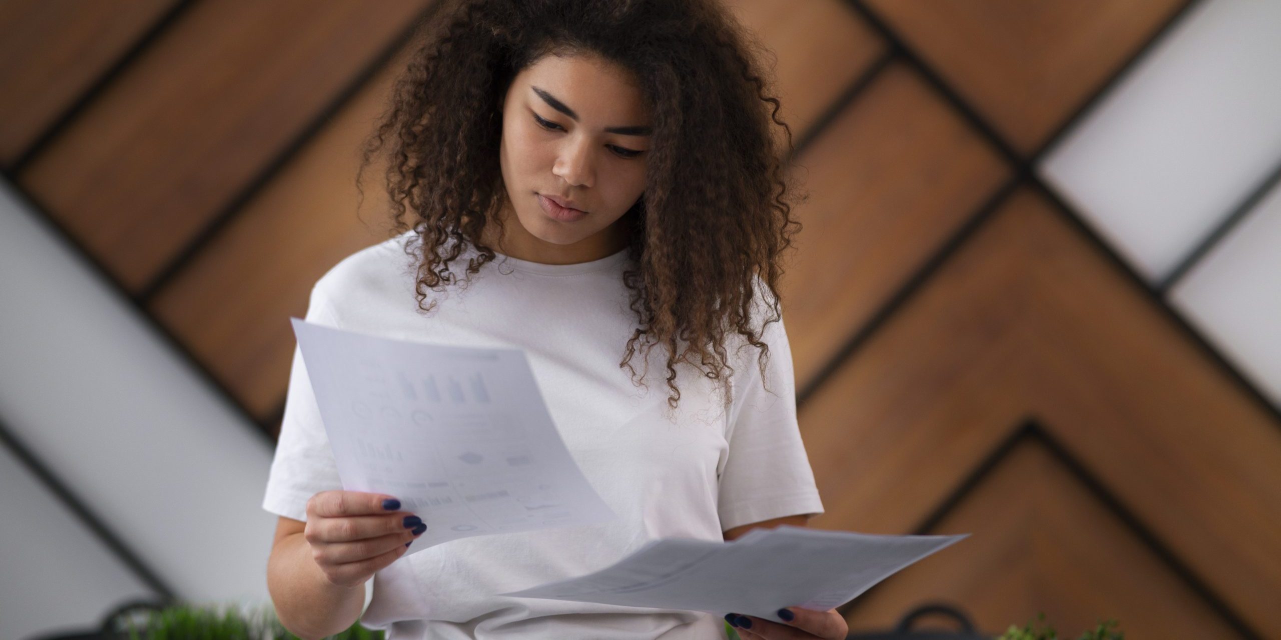 woman-office-work-fp Woman looking at folder in officee illustrate blog "What Happens When a Company Factors its Receivables?"